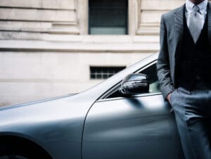 Washdoctors_Mobile-car-body-Repairs-city-worker-leaning-against-silver-car