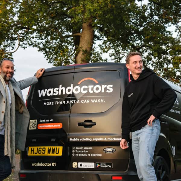 Two technicians with Washdoctors van ready for mobile car wash services.