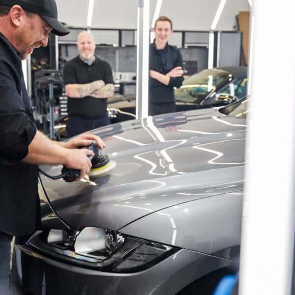 Technicians training on car polishing at Washdoctors Academy.